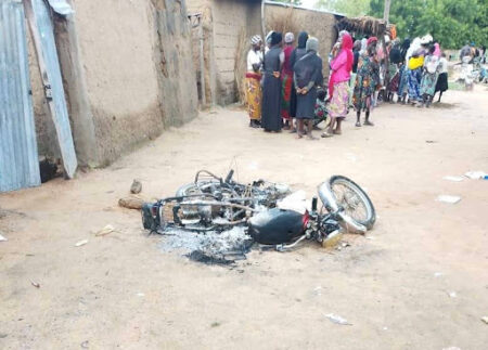 Residents flee again as insurgents burn homes, church, and vehicles in night raid.